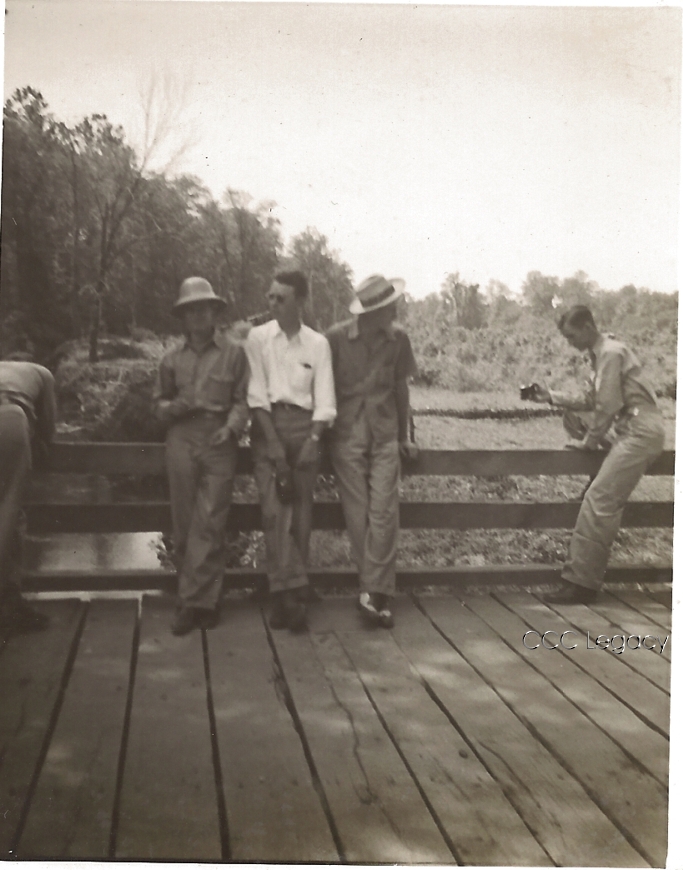 CCC enrollees resting on a bridge they built in Virginia, 1930s — representative of the 41,303 bridges and 125,000 miles of roads constructed by the Corps